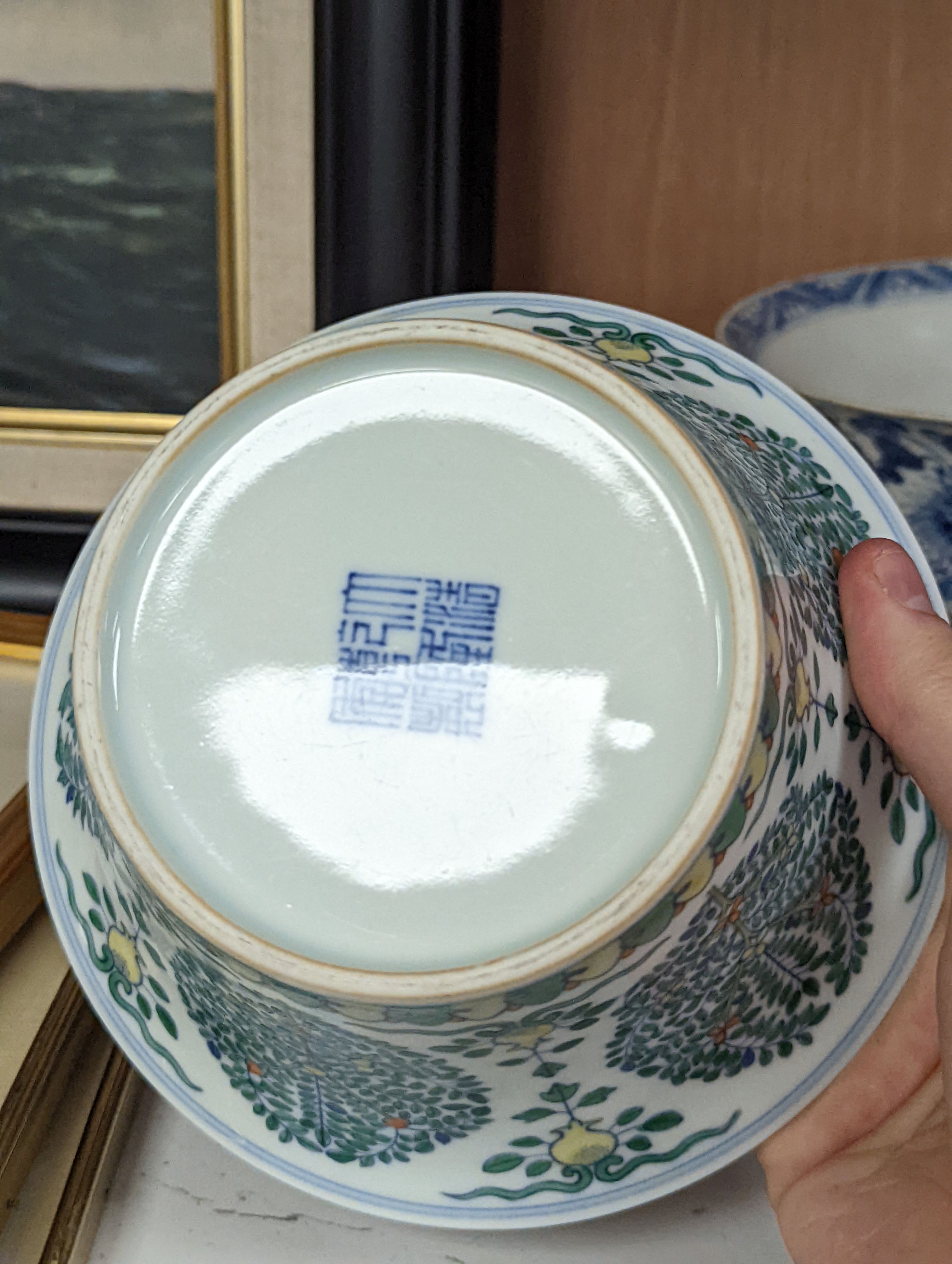 A Chinese blue and white bowl, Kangxi, 15cm. diam., a famille rose teapot stand, Yongzheng, and two doucai bowls